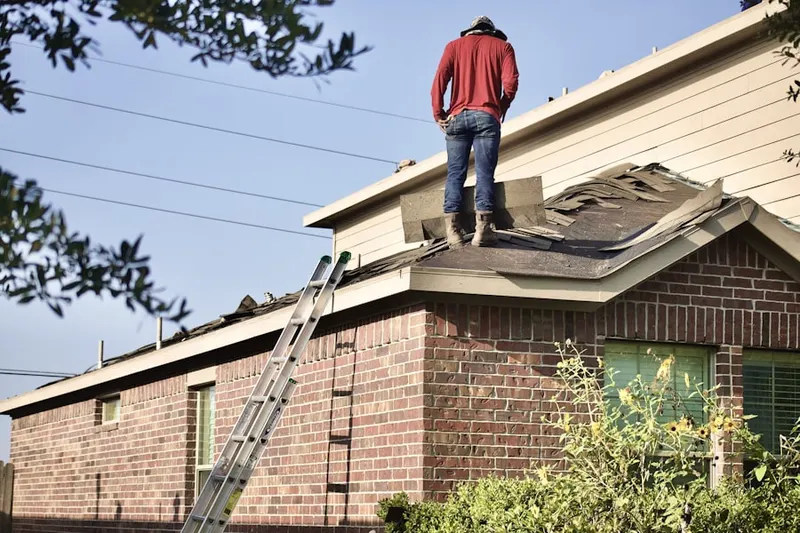 Professional roofer working on a residential roof in Hadley